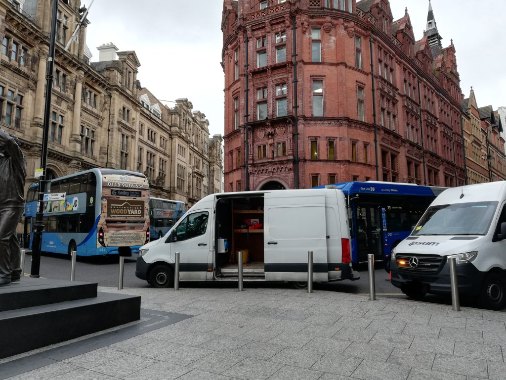 Vans and buses in front of Prudential Justice building on King street taken in 2025