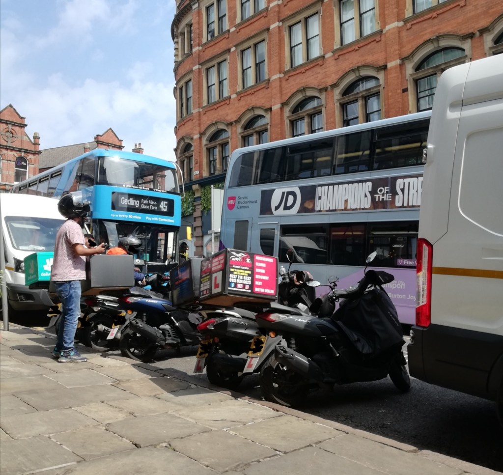 Buses, delivery vans and take away drivers parked on king street, Nottingham in 2025